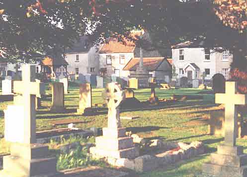 Churchyard showing lychgate and war memorial